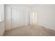 A simple bedroom with a sliding door closet and neutral carpet provides a blank canvas at 4323 Village Spring St, Las Vegas, NV 89147