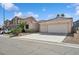 Lovely single-story home with desert landscaping, a three-car garage and a spacious driveway at 4323 Village Spring St, Las Vegas, NV 89147