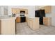 The kitchen offers an island, ample cabinet space, and matching black appliances at 4323 Village Spring St, Las Vegas, NV 89147