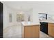 Bright kitchen area offers tiled flooring, a ceiling fan, and a center island at 4323 Village Spring St, Las Vegas, NV 89147