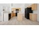 Open kitchen boasts an island, tile flooring, bright cabinets, and modern appliances at 4323 Village Spring St, Las Vegas, NV 89147