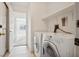 Functional laundry room equipped with white appliances and additional shelving at 4323 Village Spring St, Las Vegas, NV 89147