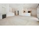 Open floor plan with fireplace, neutral carpet, connecting to the kitchen at 4323 Village Spring St, Las Vegas, NV 89147