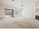 Bright living room features carpet, large windows, and a cozy fireplace at 4323 Village Spring St, Las Vegas, NV 89147