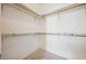 Spacious walk-in closet with neutral carpet and wood and metal racks at 4323 Village Spring St, Las Vegas, NV 89147