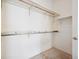 Spacious walk-in closet with neutral carpet and wood and metal racks at 4323 Village Spring St, Las Vegas, NV 89147