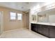 Bright bathroom boasts a double sink vanity, lots of mirror space, and tile flooring at 462 Fortissimo St, Henderson, NV 89011