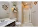 Well-lit bathroom with glass enclosed shower, decorative wall art, and dark-stained vanity at 462 Fortissimo St, Henderson, NV 89011