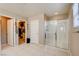 Spacious bathroom features a shower with glass doors, and a doorway to a walk-in closet at 462 Fortissimo St, Henderson, NV 89011