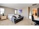 Carpeted bedroom features a writing desk, comfortable seating and bright, sunny windows at 462 Fortissimo St, Henderson, NV 89011