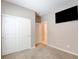 Clean bedroom design with a wall-mounted television, closet with white doors, and neutral carpeting at 462 Fortissimo St, Henderson, NV 89011
