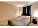 Bedroom with a comfortable bed, side tables, dark curtains, and neutral walls and carpet at 462 Fortissimo St, Henderson, NV 89011