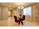 Bright dining area with modern chandelier, glass table, and comfortable red chairs at 462 Fortissimo St, Henderson, NV 89011