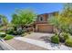 Beautiful home with lush landscaping, mature trees, and a two-car garage at 462 Fortissimo St, Henderson, NV 89011