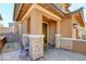 Attractive front porch with stone accents, a comfortable chair, and a welcoming entrance at 462 Fortissimo St, Henderson, NV 89011