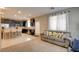 Open living area showcases kitchen, comfortable seating with decorative pillows, and natural light from draped window at 462 Fortissimo St, Henderson, NV 89011