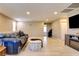 Spacious living room with new flooring and a comfortable denim couch at 462 Fortissimo St, Henderson, NV 89011