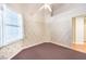 Corner bedroom with a window, patterned wallpaper, carpet, and closet space at 504 Arthur Ave, Henderson, NV 89015
