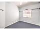 Cozy bedroom with neutral walls and carpet, featuring a window with curtains at 504 Arthur Ave, Henderson, NV 89015