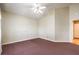 Spacious bedroom with high ceiling, ceiling fan, and carpet flooring at 504 Arthur Ave, Henderson, NV 89015