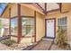 Inviting front entrance featuring a white door, sidelight window, and neatly landscaped flowerbed at 504 Arthur Ave, Henderson, NV 89015