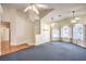 Bright living room with neutral paint, carpet, and multiple windows offering abundant natural light at 504 Arthur Ave, Henderson, NV 89015