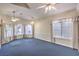 Bright living room with neutral paint, carpet, and multiple windows offering abundant natural light at 504 Arthur Ave, Henderson, NV 89015