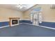 Open living area with fireplace, back patio access, and blue carpet at 504 Arthur Ave, Henderson, NV 89015