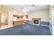 Open concept living area, kitchen, and fireplace with a large window and entry door at 504 Arthur Ave, Henderson, NV 89015