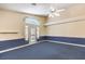 Inviting living room featuring blue carpet, high ceiling, and a ceiling fan at 504 Arthur Ave, Henderson, NV 89015