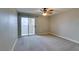 Spacious bedroom with a sliding glass door to a balcony and neutral carpeting at 698 S Racetrack Rd # 114, Henderson, NV 89015