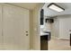 View of the home's entryway, with a white door and a glimpse into the kitchen area at 698 S Racetrack Rd # 114, Henderson, NV 89015