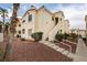 Condominium exterior featuring well-maintained landscaping and stairs leading to the units at 698 S Racetrack Rd # 114, Henderson, NV 89015