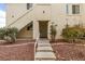 Condo exterior showcasing the entryway and landscaping, with stairs leading to the front door at 698 S Racetrack Rd # 114, Henderson, NV 89015