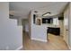 Open concept kitchen with modern appliances, adjacent to a living area at 698 S Racetrack Rd # 114, Henderson, NV 89015