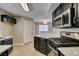 Modern kitchen featuring stainless steel appliances, dark cabinetry, and bright countertops at 698 S Racetrack Rd # 114, Henderson, NV 89015