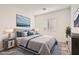 Staged bedroom featuring a queen bed, wood furniture, neutral carpet, and blue accents at 762 Star Estates Ave # 0, North Las Vegas, NV 89086