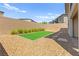 Well-maintained backyard featuring artificial turf and desert landscaping at 767 Tallgrass St, Las Vegas, NV 89138