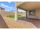 This backyard features gravel, greenery, and covered patio area at 767 Tallgrass St, Las Vegas, NV 89138