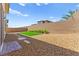 Well-maintained backyard featuring artificial turf and desert landscaping at 767 Tallgrass St, Las Vegas, NV 89138