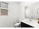 This bathroom features a mirror, dark vanity, and a window to let in natural light at 767 Tallgrass St, Las Vegas, NV 89138