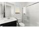 This bathroom features a sliding glass shower, a window, and dark vanity at 767 Tallgrass St, Las Vegas, NV 89138