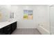 Well-lit bathroom with double vanity, a large window, and a separate soaking tub at 767 Tallgrass St, Las Vegas, NV 89138