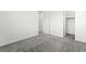 Bright bedroom boasts neutral walls, gray carpet, and a closet at 767 Tallgrass St, Las Vegas, NV 89138