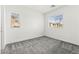 This is a bright bedroom features neutral walls, gray carpet, and window at 767 Tallgrass St, Las Vegas, NV 89138