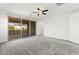 Spacious bedroom with plush carpet, ceiling fan, and sliding glass doors to a private balcony at 767 Tallgrass St, Las Vegas, NV 89138