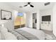 A virtually staged bedroom features a queen sized bed, tile floors, and backyard access at 767 Tallgrass St, Las Vegas, NV 89138