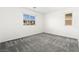 Bright bedroom boasts neutral walls, gray carpet, and natural light at 767 Tallgrass St, Las Vegas, NV 89138