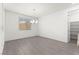 Bright dining room with a modern chandelier and large window, next to a pantry at 767 Tallgrass St, Las Vegas, NV 89138