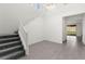 Grand entryway with high ceilings, modern light fixture, sleek tile flooring, and a staircase with white railing at 767 Tallgrass St, Las Vegas, NV 89138